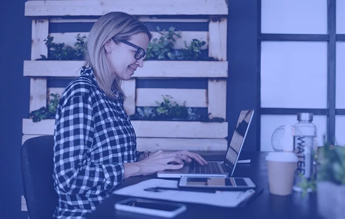 Smiling woman looking at the camera holding a pen