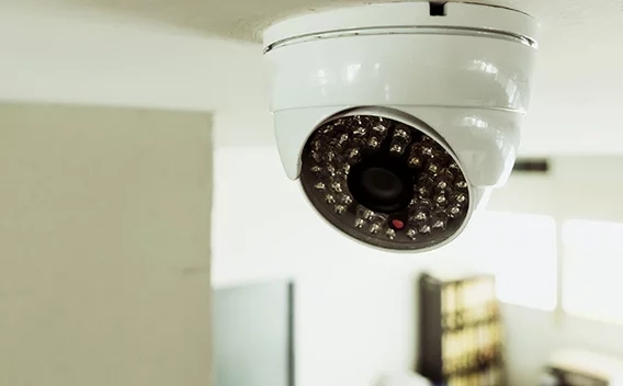 Security camera mounted on an office ceiling
