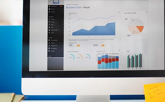 Desktop computer with charts and graphs on the screen